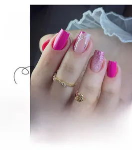 Detail of French style press-on nails featuring pink glitter gradient and line art