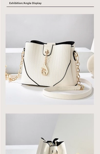 Detail view of cream bucket bag showing gold fox pendant and leather chain strap
