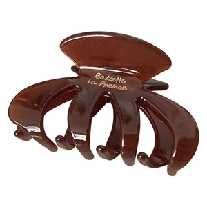 Brown oval hair claw clip with gold lettering for elegant French updo hairstyles