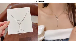 Detail of silver crescent moon and pearl bow necklace with model wearing shot