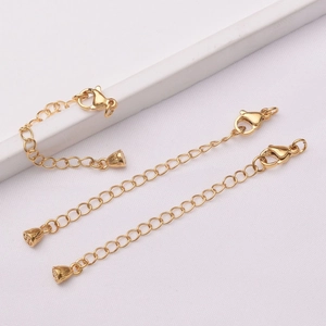 Detail view of 24k gold-plated lobster clasps with heart charms and extender chains