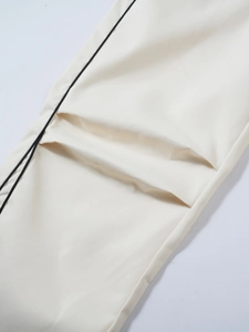Detail of off-white twill fabric with black drawstring and high-quality stitching