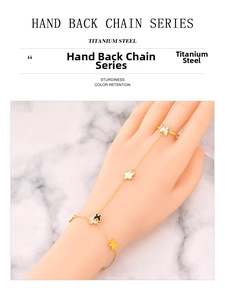 Detailed close-up of gold titanium steel hand back chain with butterfly and shell charms