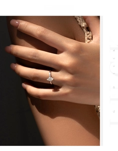 Close-up of marquise-cut moissanite solitaire ring on finger in 925 sterling silver