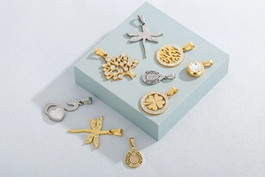 Close-up of tree of life and dragonfly pendants with rhinestones in gold and silver