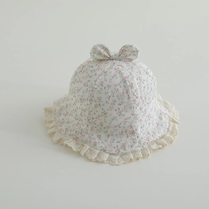 Detail of floral baby sun hat showing delicate lace brim and decorative bow knot