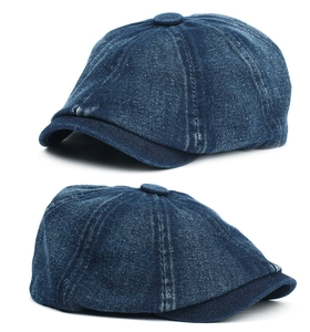 Detailed view of heavy-duty washed blue denim newsboy cap with classic button top