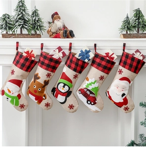 Detailed view of five hanging Christmas stockings with burlap texture and festive embroidery
