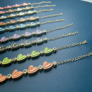 Close-up of colorful heart enamel bracelets with sparkling zircon accents and gold plating