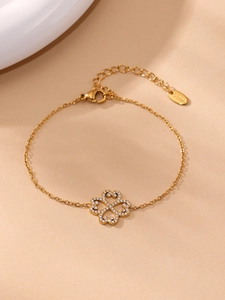 Macro detail of stainless steel clover bracelet with 5A zircons and lobster clasp closure