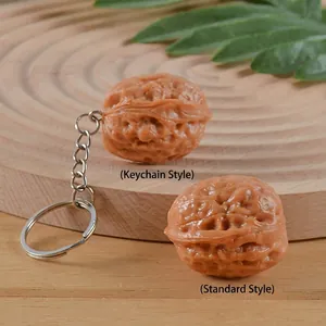 Realistic PVC walnut charms in keychain and standard versions on a rustic wooden tray