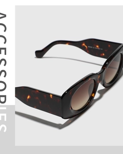 Detailed view of dark tortoise shell square sunglasses with brown gradient lenses