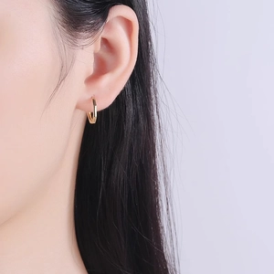 Elegant gold S925 silver octagonal hoop earrings worn by a model in a soft lighting