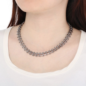 Close-up of polished silver 12mm geometric trapezoid link chain necklace for a modern look