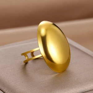 Macro shot of polished gold geometric ring showing a smooth curved mirror finish on display