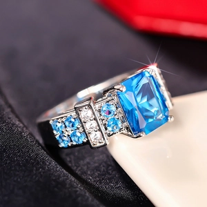 Macro view of square blue gemstone ring with micro-pave diamonds on the band