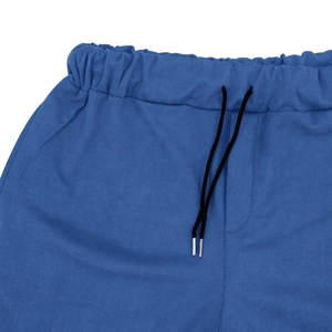 Detail view of navy faux suede pants featuring elastic waist with black drawstring and metal tips