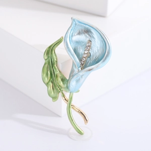 Elegant blue enamel morning glory brooch with gold leaves and crystals on white base
