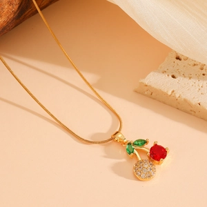 Elegant gold titanium chain necklace with sparkling red crystal cherry pendant and leaf