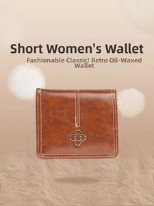 Detail view of brown vintage oil wax leather wallet with metal flower logo and white stitching