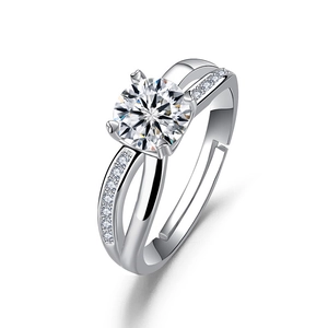 Detail of four-prong silver ring with large round solitaire and side-pave diamonds