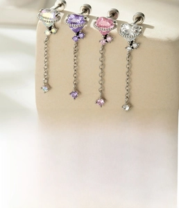 Detailed view of titanium steel heart zircon tassel earrings in four colors on stone props
