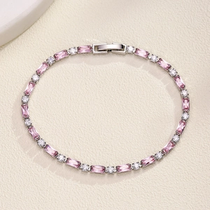 Detail of tennis bracelet with pink baguette stones and white round zircons on cream base