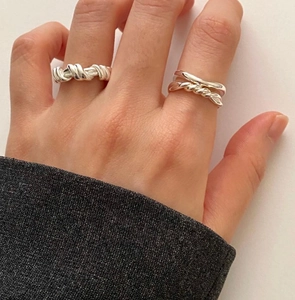 Close-up of minimalist 925 sterling silver knotted twist and double-layered hollow rings