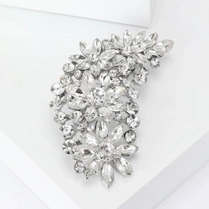 Detailed shot of a silver floral brooch featuring sparkling inlaid rhinestones