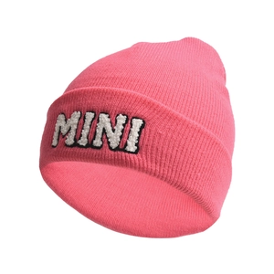 Close-up of pink knitted beanie featuring white 3D plush MINI letter embroidery detail