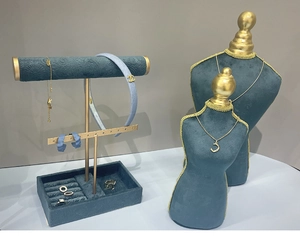 Blue velvet jewelry display set with gold metal stands for necklaces and earrings
