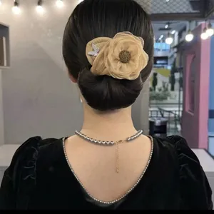 Elegant champagne floral hair bun clip with mesh petals and butterfly detail for women