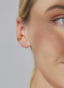 Close-up of a three-layer gold-plated ear cuff on a model with a stylish minimalist design