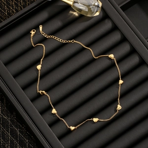 Elegant gold heart pendant necklace with adjustable chain displayed on a jewelry tray