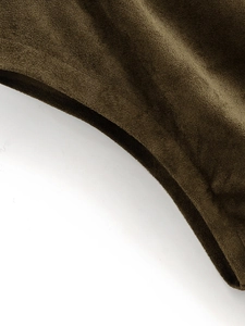 Detailed macro view of dark green faux suede fabric texture for women's asymmetric dress