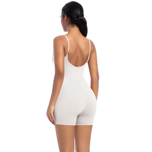Close-up of the white open-back bodysuit with thin straps and elastic seamless fabric
