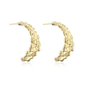 Gold plated C-shaped earrings with irregular hollow metal texture on white background