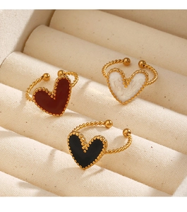 Detail view of heart rings with black red and white enamel on twisted gold bands