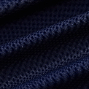 Macro detail of breathable navy blue knitted polo fabric showing mesh texture
