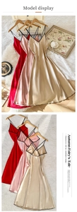 Detail of satin slip dress showing cross-back design and smooth silky texture