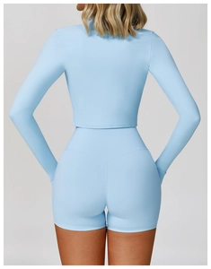 Rear view of sky blue long-sleeve crop top and high-waisted shorts with V-shaped stitching