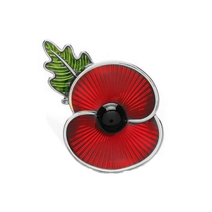 Detailed close-up of a red poppy brooch with green leaves and enamel finish