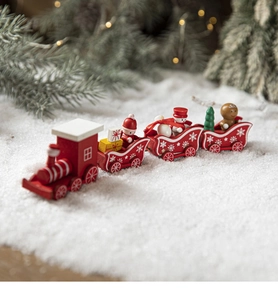 Detail of wooden Christmas train toy with Santa Claus, snowmen and festive pine branches