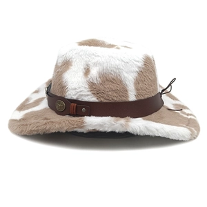 Detailed cow print cowboy hat with plush texture, faux leather band, and metal studs
