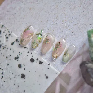 Macro detail of Chinese style gold bamboo nail stickers with delicate pearls and marbling