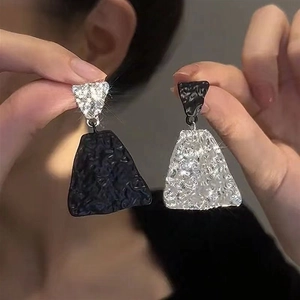 Asymmetric crumpled geometric triangle earrings with black and silver contrast finish