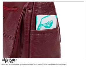 Detail of burgundy lychee leather side pocket with white card for capacity demo