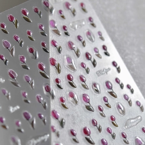 Macro shot of 3D embossed jelly tulip nail stickers with floral patterns and lettering