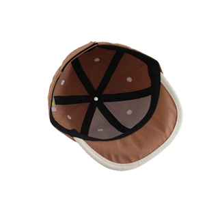 Interior view of caramel baby baseball cap with reinforced seams and brand label