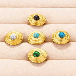 Adjustable spiral stainless steel rings with colorful marble stones on display